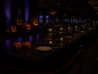 Moody Halloween-decorated Las Vegas casino buffet with pumpkins and purple lighting